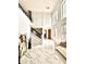 Bright foyer boasts soaring ceilings, marble floors, and a striking staircase with iron railings at 1407 Water Lilly Ln, Kissimmee, FL 34744