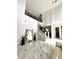 Bright foyer boasts soaring ceilings, marble floors, and a striking staircase with iron railings at 1407 Water Lilly Ln, Kissimmee, FL 34744