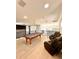 Bright game room featuring a pool table, leather seating, and modern light fixtures at 1407 Water Lilly Ln, Kissimmee, FL 34744