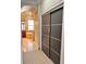 Hallway view toward the bathroom, showcasing stylish closet doors at 1407 Water Lilly Ln, Kissimmee, FL 34744