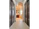 Hallway view toward the bathroom, featuring closet doors on each side at 1407 Water Lilly Ln, Kissimmee, FL 34744
