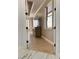 Hallway view showcasing wood flooring, a view of the bedroom, and natural lighting at 1407 Water Lilly Ln, Kissimmee, FL 34744