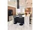 Contemporary kitchen featuring a waterfall island, pendant lighting, and a stylish breakfast bar at 1407 Water Lilly Ln, Kissimmee, FL 34744
