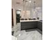 Kitchen island with barstool seating and stainless steel appliances at 1407 Water Lilly Ln, Kissimmee, FL 34744