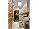 Modern laundry room features stacked washer/dryer, white cabinetry, and a black faucet at 1407 Water Lilly Ln, Kissimmee, FL 34744