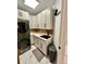 Modern laundry room features stacked washer/dryer, white cabinetry, and a black faucet at 1407 Water Lilly Ln, Kissimmee, FL 34744