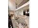 Open-concept living room with marble floors, balcony overlook, and neutral furnishings for a cozy atmosphere at 1407 Water Lilly Ln, Kissimmee, FL 34744