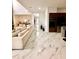 Open-concept living room boasts marble floors, neutral color scheme, and a modern kitchen view at 1407 Water Lilly Ln, Kissimmee, FL 34744