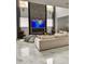 Bright living room with marble floors, fireplace, and open layout for modern living at 1407 Water Lilly Ln, Kissimmee, FL 34744