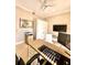 Bright home office with wood floors, ceiling fan, built-in storage, and large wall-mounted television at 1407 Water Lilly Ln, Kissimmee, FL 34744