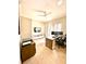 Bright home office with wood floors, a ceiling fan, a window, and a modern desk setup at 1407 Water Lilly Ln, Kissimmee, FL 34744