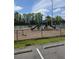 Community playground and tennis courts surrounded by black chain link fence at 1407 Water Lilly Ln, Kissimmee, FL 34744