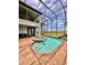 Enjoy the screened in pool and spa area with views of the lake and lush landscaping at 1407 Water Lilly Ln, Kissimmee, FL 34744