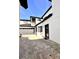 A partial view of a two story home featuring stone pavers, garage and walkway with support columns at 1407 Water Lilly Ln, Kissimmee, FL 34744