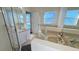 Bright bathroom featuring dual vanities, a bathtub, and a separate shower at 16732 Glenbrook Blvd, Clermont, FL 34714