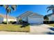 Inviting single-story home featuring an attached two-car garage and lush, green lawn at 16732 Glenbrook Blvd, Clermont, FL 34714