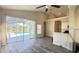 Open-concept living space with a ceiling fan, a wet bar, and access to the screened patio at 16732 Glenbrook Blvd, Clermont, FL 34714