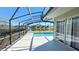 Relaxing screened patio with a view of the pool and tranquil lake at 16732 Glenbrook Blvd, Clermont, FL 34714