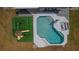 Aerial view of the house with a backyard oasis, featuring a pool and playground at 1700 E Clinton Dr, St Cloud, FL 34769