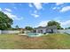 Spacious backyard featuring a pool, patio, playground, and ample green space at 1700 E Clinton Dr, St Cloud, FL 34769