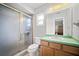Bathroom featuring a shower with a sliding glass door, toilet, and vanity with sink at 1700 E Clinton Dr, St Cloud, FL 34769