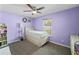 Charming bedroom featuring a ceiling fan, a window, and a cozy bed with storage drawers at 1700 E Clinton Dr, St Cloud, FL 34769
