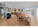 Open dining area leading to a kitchen and pool view, showcasing a large wood table at 1700 E Clinton Dr, St Cloud, FL 34769