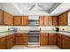 Updated kitchen with oak cabinets, stainless appliances, and white subway tile backsplash at 1700 E Clinton Dr, St Cloud, FL 34769