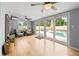 Cozy living room with hardwood floors, comfortable seating, and sliding glass doors leading to the pool area at 1700 E Clinton Dr, St Cloud, FL 34769