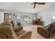 Inviting living room with light wood flooring, a bay window, and comfortable seating at 1700 E Clinton Dr, St Cloud, FL 34769