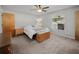 Bright main bedroom with carpeted floors, ceiling fan, and natural light at 1700 E Clinton Dr, St Cloud, FL 34769