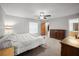 Spacious main bedroom featuring a ceiling fan, carpeted floors, and a dresser at 1700 E Clinton Dr, St Cloud, FL 34769