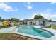 Backyard oasis featuring a sparkling pool, covered patio, and a fun playground at 1700 E Clinton Dr, St Cloud, FL 34769