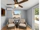 Relaxing sitting area with wicker chairs, a small table, and a view of the backyard at 1700 E Clinton Dr, St Cloud, FL 34769