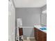 Bathroom features a double vanity with dark wood cabinets, white countertops, and a mirror at 1849 Kings Point Blvd, Kissimmee, FL 34744