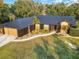 Exterior of a home with a dark metal roof and an attached front entry garage at 1849 Kings Point Blvd, Kissimmee, FL 34744