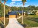 Exterior view of a home with a well-manicured lawn and dark metal roof at 1849 Kings Point Blvd, Kissimmee, FL 34744