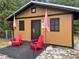 Hurricane shelter exterior with red outdoor chairs on the patio, perfect for relaxing outdoors at 1849 Kings Point Blvd, Kissimmee, FL 34744