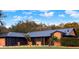 Stunning home featuring a dark metal roof and modern exterior paint scheme at 1849 Kings Point Blvd, Kissimmee, FL 34744