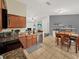 Open kitchen with granite countertops, stainless steel appliances, and adjacent dining area with a bar at 1849 Kings Point Blvd, Kissimmee, FL 34744