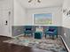 Elegant sitting area with blue accent chairs, a modern rug, and ample natural light at 1849 Kings Point Blvd, Kissimmee, FL 34744