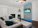 Modern living room featuring a fireplace, mounted TV with LED lights, and stylish seating at 1849 Kings Point Blvd, Kissimmee, FL 34744