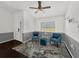 Bright living room featuring a ceiling fan, comfortable seating, and a view from the window at 1849 Kings Point Blvd, Kissimmee, FL 34744