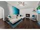 Cozy living room with white leather sofa, fireplace, and a mounted TV with blue LED lighting at 1849 Kings Point Blvd, Kissimmee, FL 34744