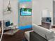 Living room showcasing a fireplace, mounted TV with LED lights, and a cozy seating area at 1849 Kings Point Blvd, Kissimmee, FL 34744