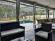 Inviting screened outdoor living space with comfortable seating overlooks a sparkling pool and private backyard at 1849 Kings Point Blvd, Kissimmee, FL 34744