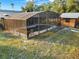 Screened-in pool area with a shed and surrounding green space at 1849 Kings Point Blvd, Kissimmee, FL 34744