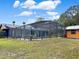 A serene screened-in pool with lounge chairs, and well maintained outdoor surroundings at 1849 Kings Point Blvd, Kissimmee, FL 34744
