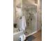 Luxurious bathroom highlighting a glass-enclosed shower with mosaic tile accents and a relaxing soaking tub at 1920 Triumfo Cir, Kissimmee, FL 34744