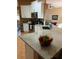 Modern kitchen featuring white cabinets, stainless steel appliances, granite counters, and an eat-in island at 1920 Triumfo Cir, Kissimmee, FL 34744